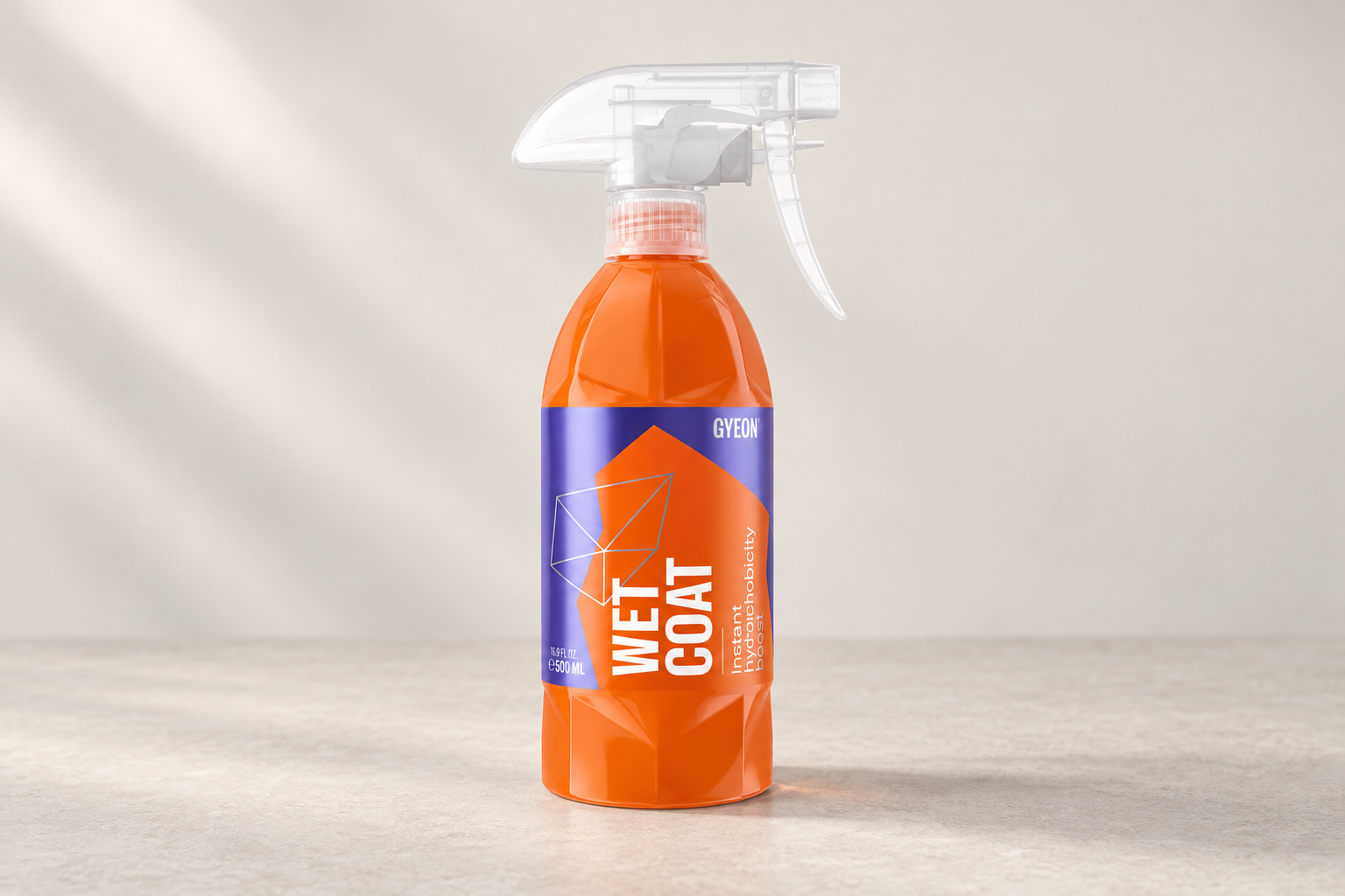 Gyeon WetCoat in its labelled bottle on a neutral surface