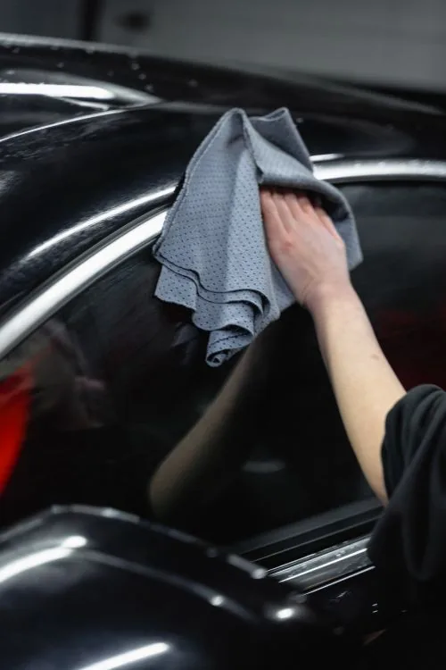 Clean cloth in contact with washed car paint
