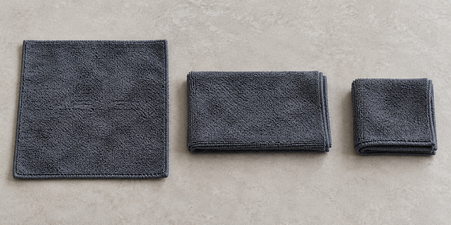 A clean microfibre laid flat, folded in half and folded again to expose fresh faces